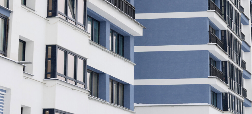 Blue facade of new modern house in city. Housing construction concept