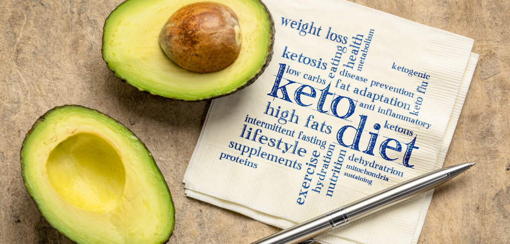 keto diet word cloud - handwriting on napkin with a cut avocado against bark paper