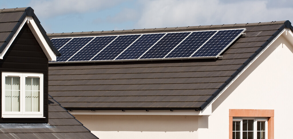 Photovoltaic Solar panels Mounted on the tiled roof of a modern residential or private home