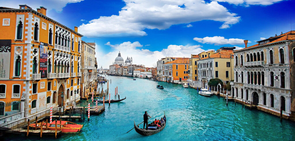 Ancient buildings and gondola along Canal Grande in Venice Italy