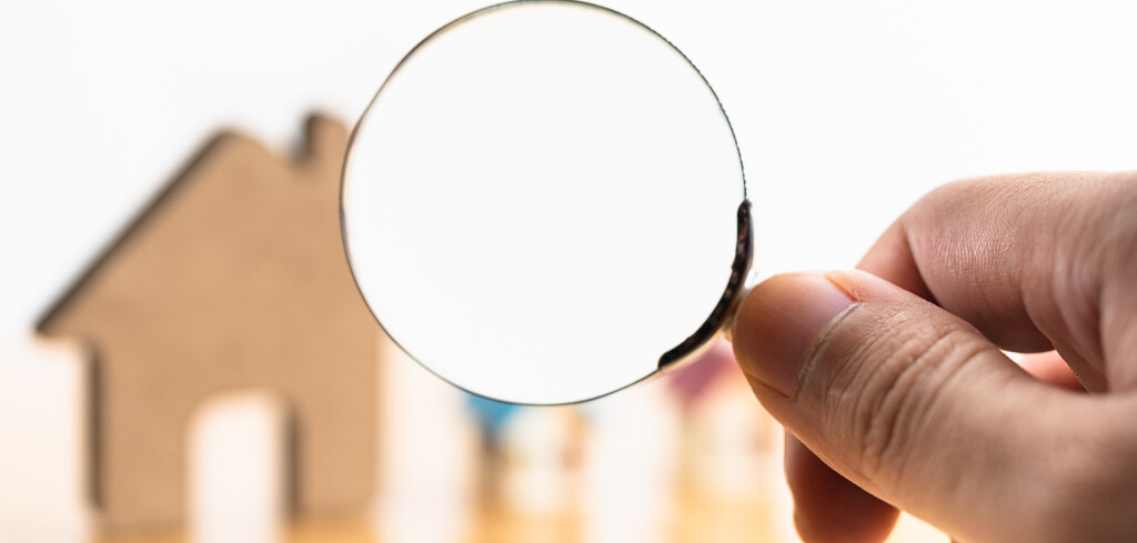 House and magnifying glass for search and explore real estate, houses, apartments for investment. Risks from Interest rate,buy,sell, or leasing in real estate. Solutions to household debt problems.