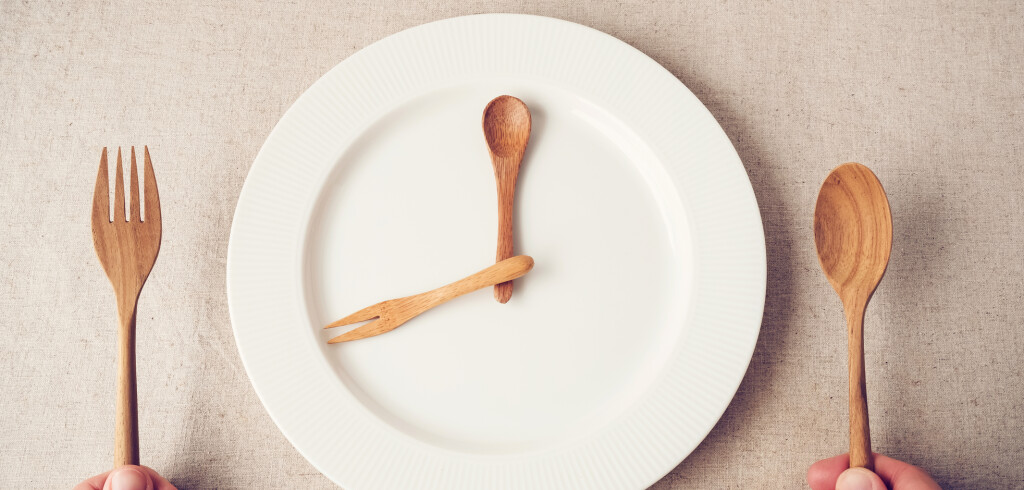 white plate with spoon and fork, Intermittent fasting concept, ketogenic diet, weight loss