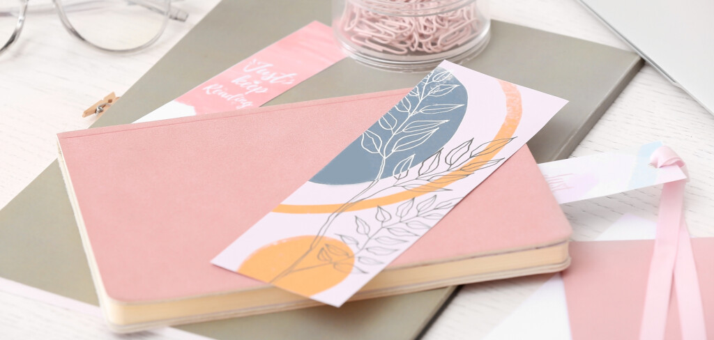 Notebooks, stationery and bookmarks on light background