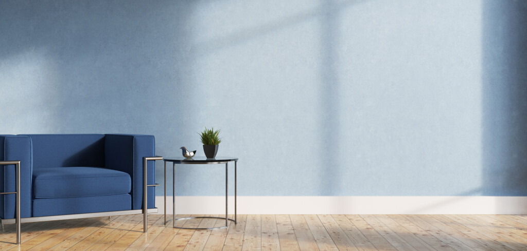Minimalistic living room interior with blue walls, a wooden floor, a soft blue and silver armchair and a tiny coffee table. 3d rendering mock up