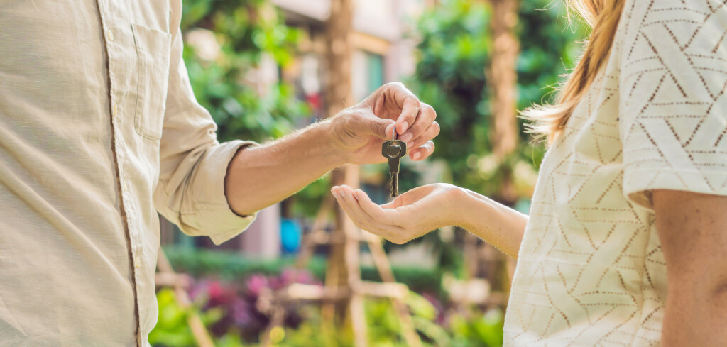 Real estate agent giving keys to apartment owner, buying selling property business. Close up of male hand taking house key from realtor. Mortgage for purchasing flat, getting access to own home.