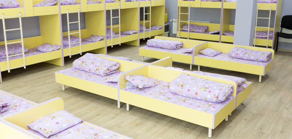 Modern kindergarten bedroom with small bunk beds with stairs for the kids.