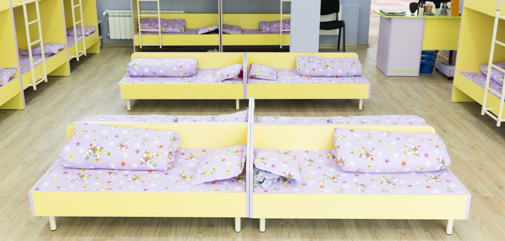 Modern kindergarten bedroom with small bunk beds with stairs for the kids.
