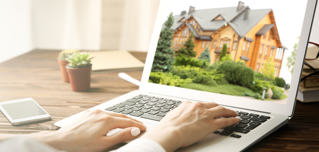 Online shopping concept. Woman looking for house on real estate market website
