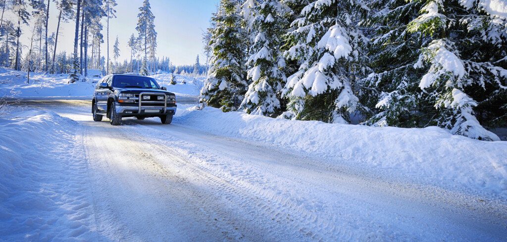 large suv driving in snowy winter conditions, scenery from sweden