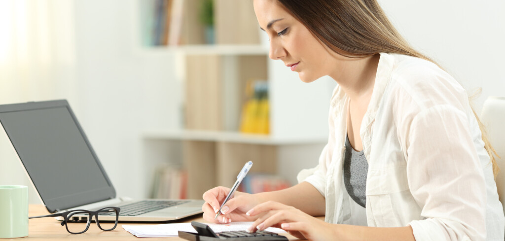 Side view portrait of a serious woman doing accounting at home