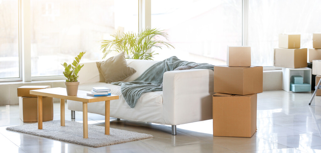 Furniture, belongings and moving boxes in room