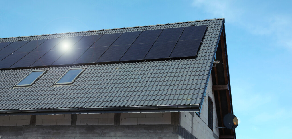 House with installed solar panels on roof. Alternative energy
