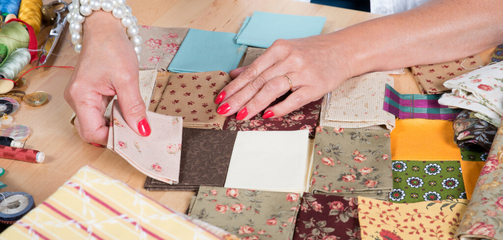 Close up of woman's hand sewing patchwork